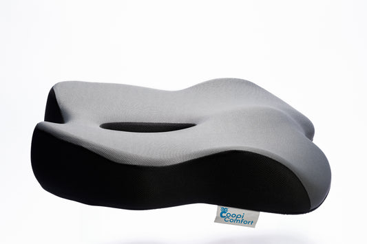 Ergonomic back pillow with dark mesh cover and 'Coopi Comfort' logo tag.